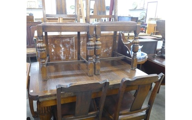 A carved oak draw leaf table and four chairs