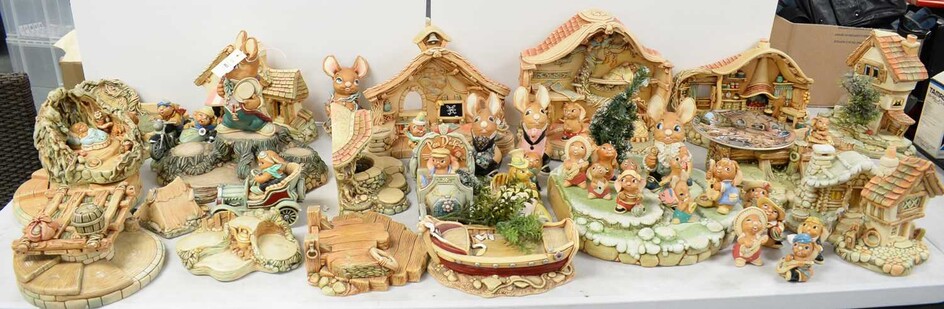 A collection of Pendelfin figures and model houses.