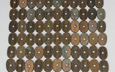 A collection of sixty-eight Japanese 1835-1870 100 Mon Tempo Tsuho oval coins.