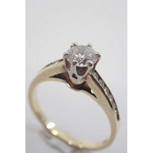 A diamond solitaire ring set with diamond shoulders, estimat...