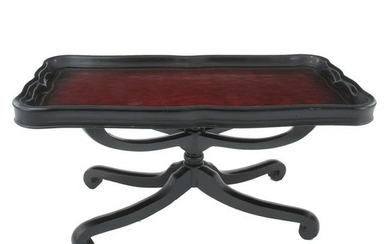 A fake leather lacquered top ebonized wood tea table