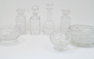 A group of cut glass bowls and decanters, 20th century, to include a bulb shaped decanter with elongated neck and flat base, with stopper, 27cm high; two rectangular decanters with diamond moulded band to the body and rectangular stoppers, 22cm...