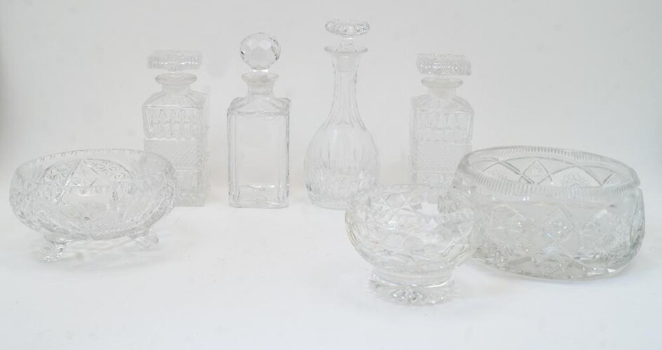 A group of cut glass bowls and decanters, 20th century, to include a bulb shaped decanter with elongated neck and flat base, with stopper, 27cm high; two rectangular decanters with diamond moulded band to the body and rectangular stoppers, 22cm...