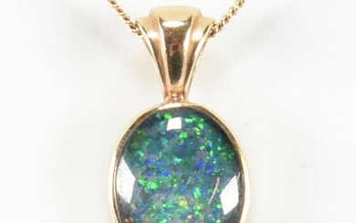 A hallmarked 9ct gold and opal doublet pendant necklace. The...