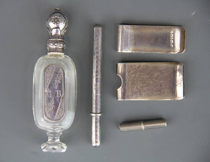 A hallmarked silver money clip, together with a 925 silver money clip, an early 19th Century Dutch silver finished cut glass perfume bottle