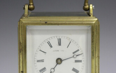 A late 19th century French brass one-piece cased carriage alarm clock with eight day movement striki