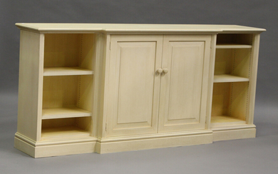 A modern cream painted breakfront side cabinet, the central cupboard flanked by shelves, height 84cm