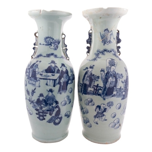 A pair of Chinese celadon ground baluster vases with lion-do...