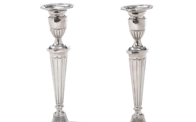 A pair of English Georgian form silver candlesticks, fluted tapering stems on...