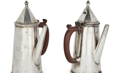 A pair of George V silver café-au-lait pots, Birmingham, 1915, retailed by Ogdens of Harrogate (maker's marks rubbed), both pots of tapering form with conical covers and wooden side handles, 21.2cm high, total weight approx. 29.2 (2) Provenance:...