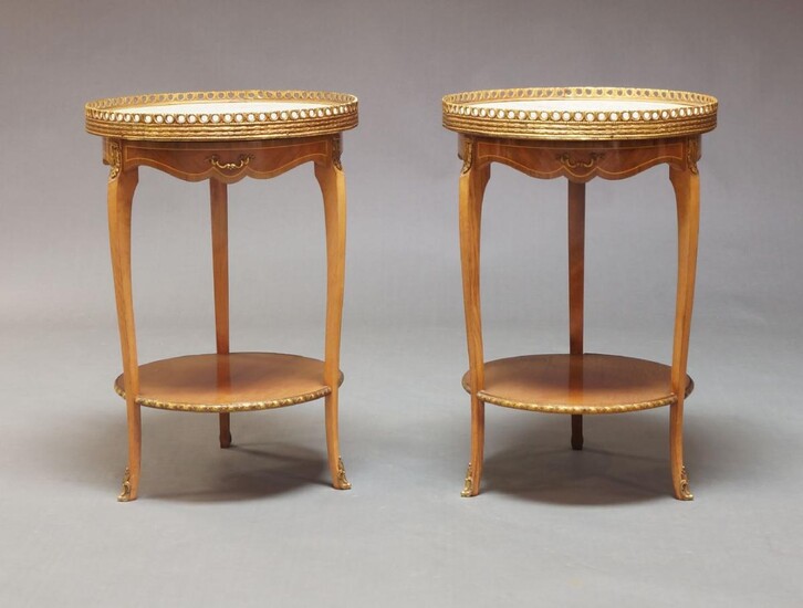 A pair of Louis XVI taste kingwood and gilt metal mounted gueridons, second half 20th Century, with circular white marble top and pierced gallery, above single frieze drawer, over circular undertier on square cut curvilinear legs, each 66.5cm high...