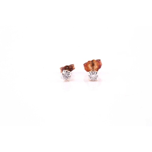 A pair of diamond ear studs, each illusion set in white with...
