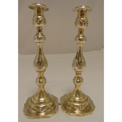A pair of hallmarked silver table candlesticks, knopped balu...