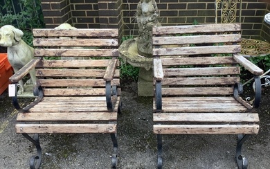 A pair of slatted wrought iron garden elbow chairs, width 61...