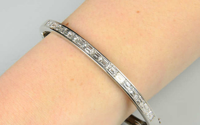 A platinum rectangular-shape diamond line hinged bangle.
