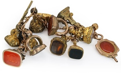 A rose gold bracelet suspending assorted fob seals and watch keys