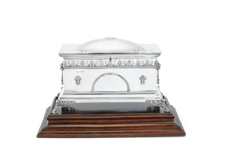 A silver casket and stand