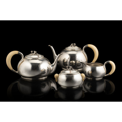 A silver tea and coffee set with ivory handles, composed of: a teapot, a coffee pot, a sugar bowl and...