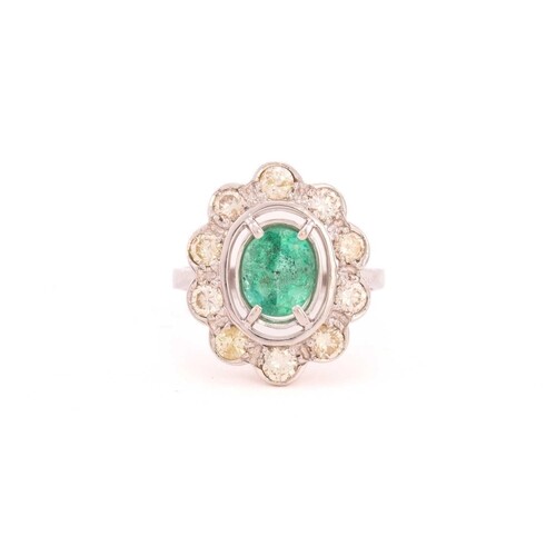 A synthetic emerald and diamond entourage ring, centrally se...