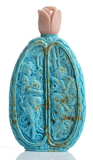 A turquoise bottle shaped sculpture with Bokè or angel...