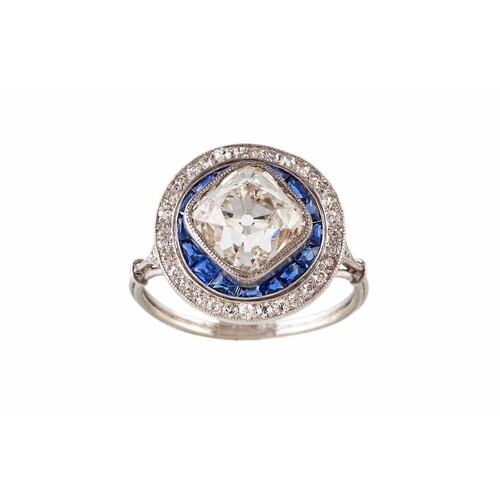 AN ART DECO DIAMOND AND SAPPHIRE TARGET CLUSTER RING, the ce...