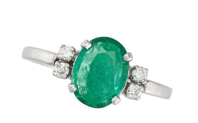 AN EMERALD AND DIAMOND RING set with an oval cut emerald of approximately 1.45 carats, accented on