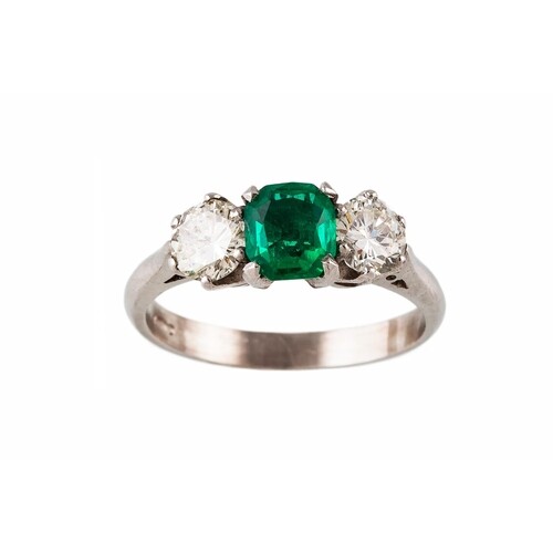 AN EMERALD AND DIAMOND THREE STONE RING, the trap cut emeral...