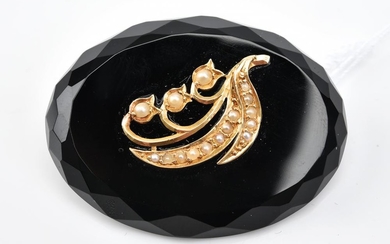AN ONYX AND SEED PEARL BROOCH