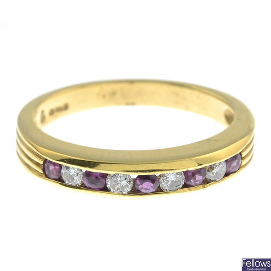 An 18ct gold ruby and diamond half eternity ring.