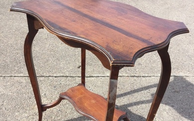 An Edwardian mahogany occasional table with serpentine moulded top above...