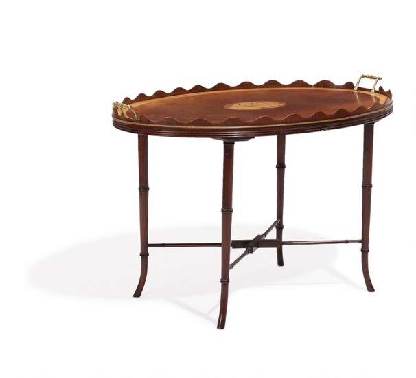 An English Regency style mahogany tray table, top inlaid with intarsia, “faux bamboo” base. Early 20th century. H. 55. L. 87. W. 55 cm.
