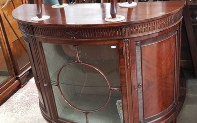 An early 20th century mahogany demi-lune display cabinet.