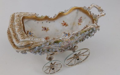 An early 20thC German porcelain model pram, painted flowers...