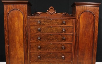 An early Victorian mahogany compactum wardrobe, shaped crest...