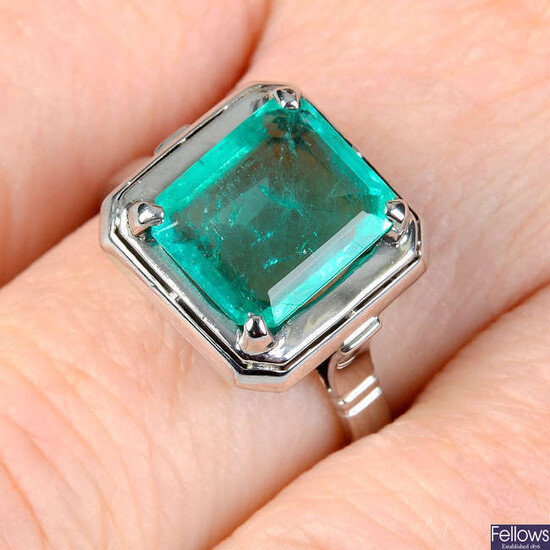 An emerald single-stone ring.