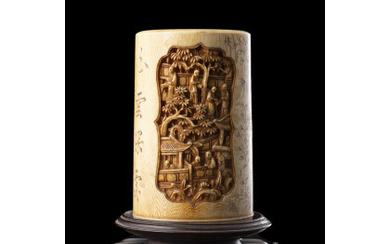 An ivory brush pot, finely carved with figures and pagodas motifs, on wood base (defects) China, Canton, late 19th century...