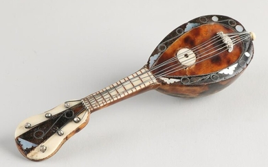 Antique mandolin glued with tortoise and