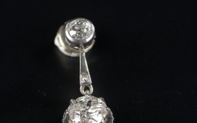 Earring in 18k white gold, set closed with a round old cut diamond of about 0.5 ct, holding another round old cut diamond of about 2 ct.