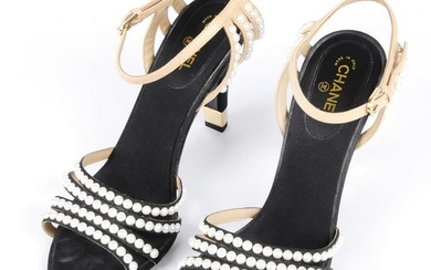 CHANEL - a pair of heeled pearl trimmed sandals.
