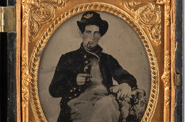 [CIVIL WAR]. Sixth plate tintype of a Union soldier, likely western theater, smoking with a unique smoking apparatus.
