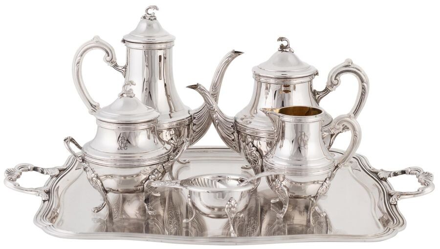 Coffee and tea set made in punched Spanish silver with vegetable and scallop decoration. 20TH CENTURY. Approximate weight: 5.739 gr. Composed by coffee pot, teapot, sugar bowl, milk jug, strainer and tray. With the initials "R.G" engraved on each...