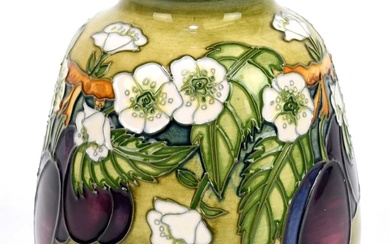 DEBBIE HANCOCK FOR MOORCROFT; a squat vase decorated with fruit...