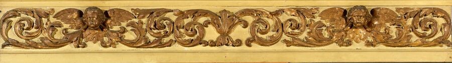 Element of carved woodwork, gilded and green rechampi decorated with angel heads and acanthus scrolls.