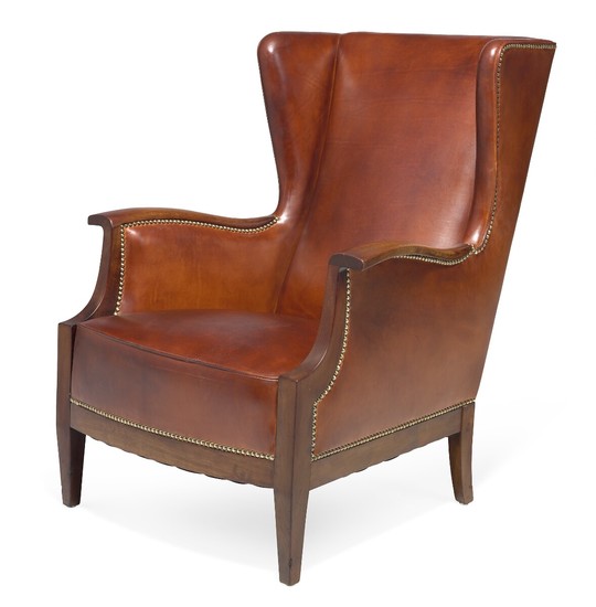 Frits Henningsen: Mahogany easy chair with curvy armrests. Sides, seat and back upholstered with cognac coloured leather, fitted with brass nails.