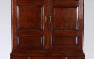 George III oak linen press chest, circa 1760, the concave cornice above a dentil frieze and a pair