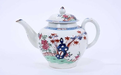 Large Lowestoft teapot and cover, of globular form with a curved spout and mushroom finial, painted in colours with rockwork and plants within a fenced enclosure, the underglaze blue border with ir...