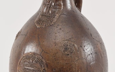 Large bellarmine early stoneware jug with bearded face and medallion decoration. 17in high.