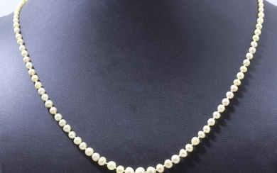 Necklace made of a drop of baroque fine pearls of about 2.3 to 6.7 mm, adorned with a silver clasp 800 thousandths punctuated with blue and white stones with safety chain. French work circa 1920/30.