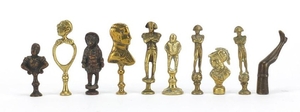 Ten antique pipe tampers including Napoleon, bust of a femal...