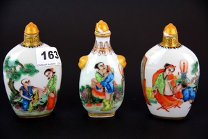 Three Chinese porcelain snuff bottles with erotic decoration, H. 12cm.